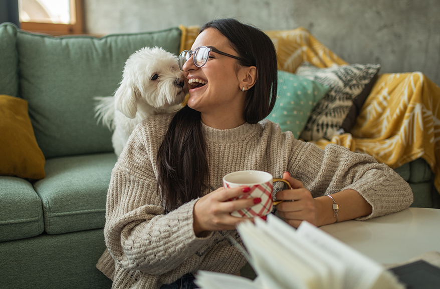 young woman and a small dog relaxing at home